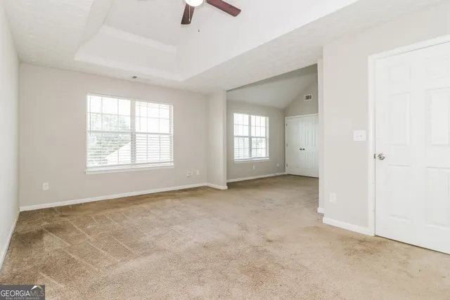 a view of an empty room with a window