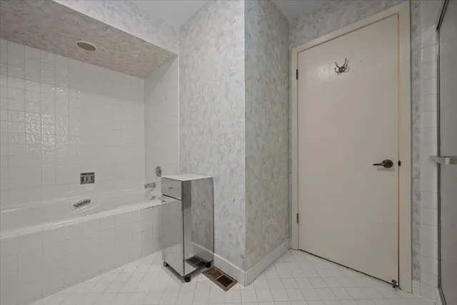 a bathroom with a bathtub and a shower