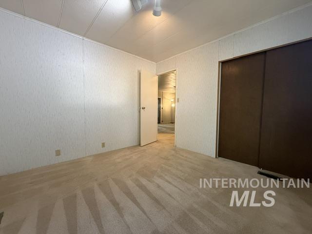 1360 Pioneer Road Weiser, ID 83672 - Photo 19 of 47 Carpeted interior room featuring textured wall paneling and a ceiling fan