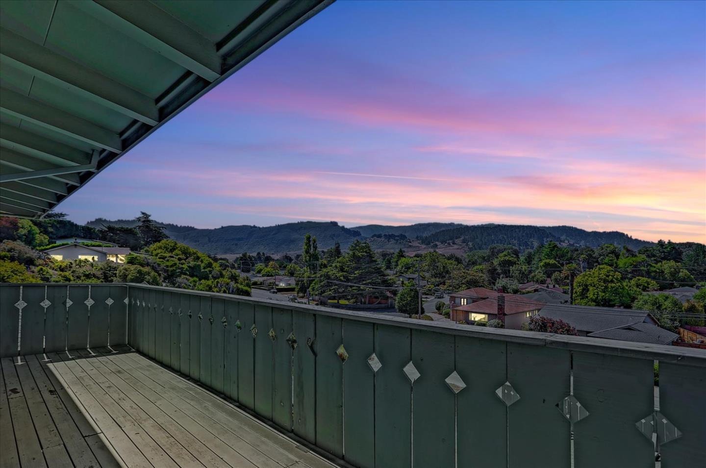 a view of balcony with wooden floor and city view