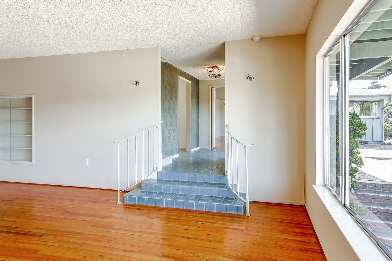 3235 Rio Road Carmel, CA 93923 - Photo 12 of 40 a view of a hallway with wooden floor and staircase