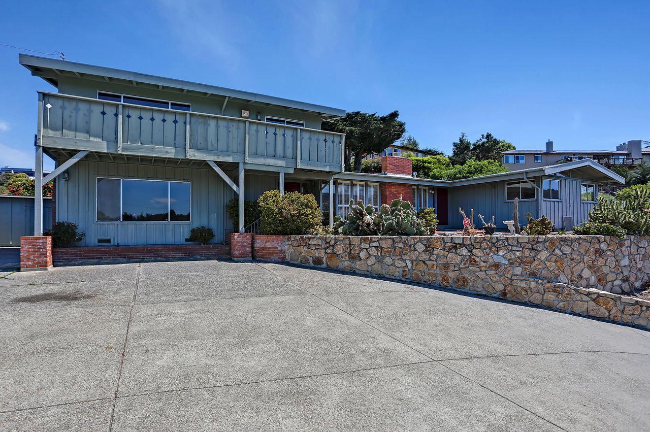 3235 Rio Road Carmel, CA 93923 - Photo 3 of 40 a view of a house with a yard and potted plants