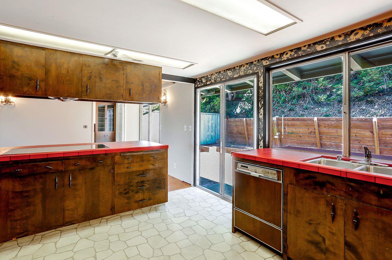3235 Rio Road Carmel, CA 93923 - Photo 21 of 40 a view of a living room with a large window and kitchen view
