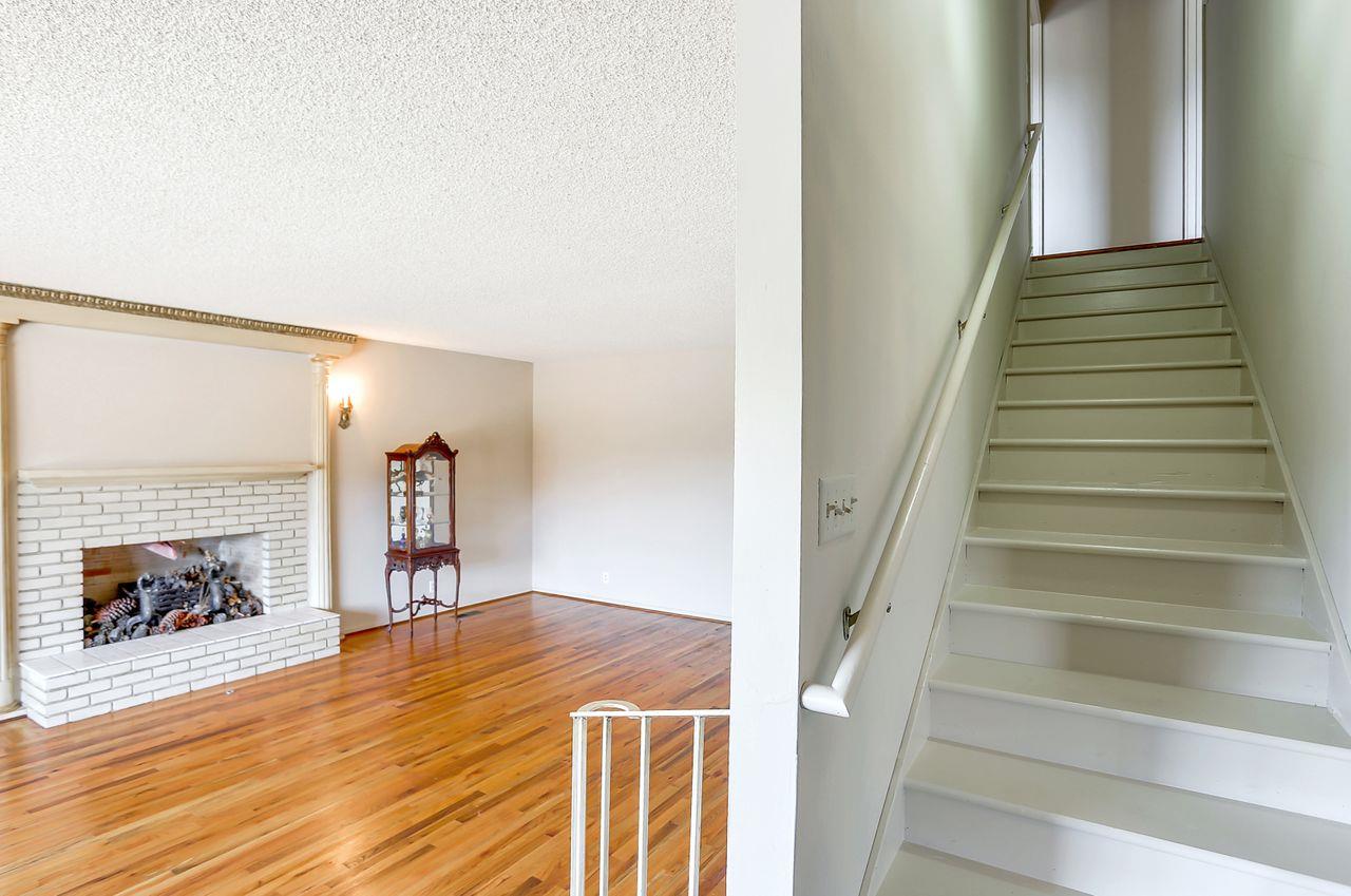 3235 Rio Road Carmel, CA 93923 - Photo 22 of 40 a view of a livingroom with wooden floor and a fireplace