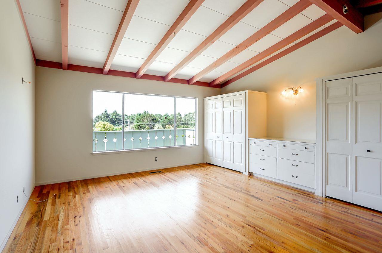 3235 Rio Road Carmel, CA 93923 - Photo 25 of 40 an empty room with wooden floor and windows
