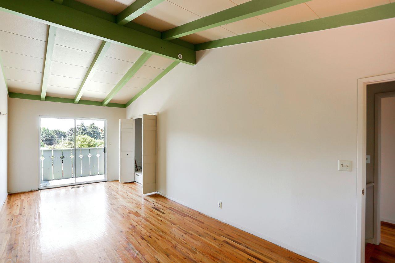 3235 Rio Road Carmel, CA 93923 - Photo 29 of 40 a view of an empty room with wooden floor and a window