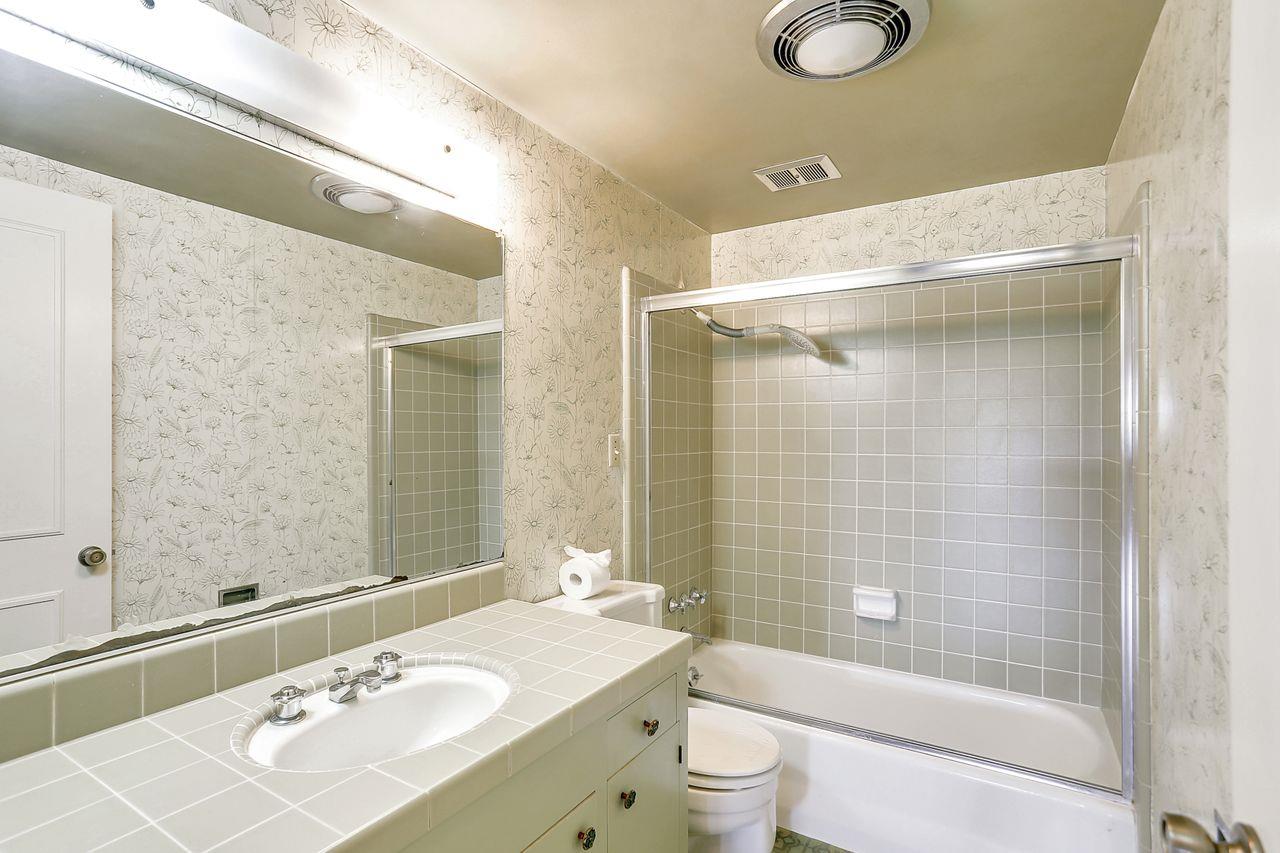 3235 Rio Road Carmel, CA 93923 - Photo 31 of 40 a bathroom with a sink a toilet and shower