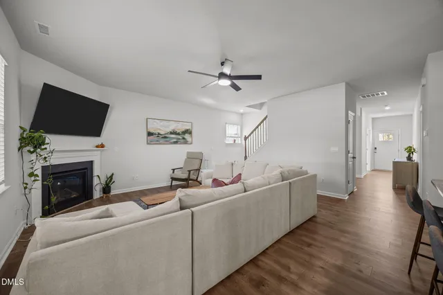 a living room with furniture a fireplace and a flat screen tv