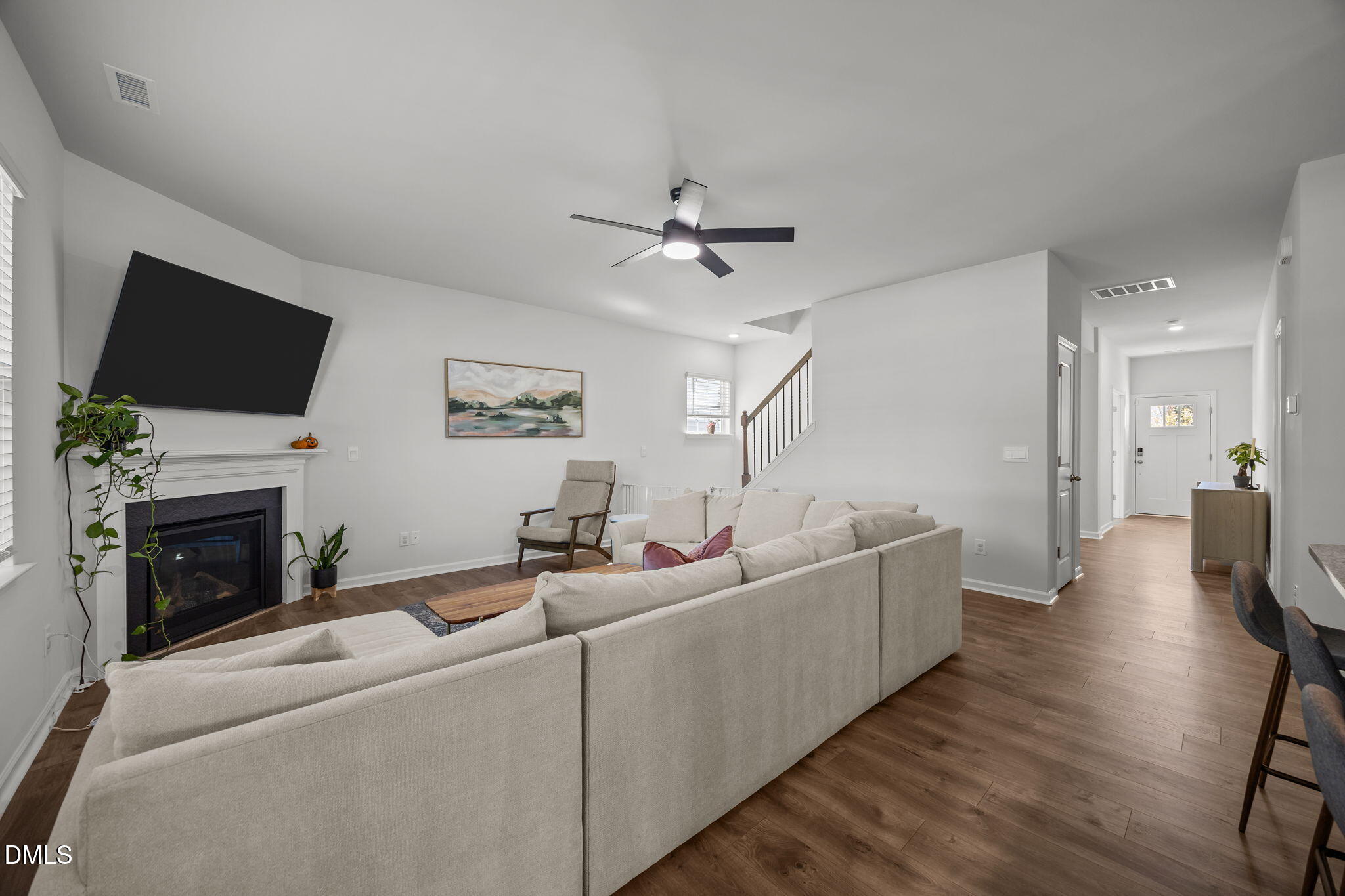 2117 Fletchers Ridge Drive Durham, NC 27703 - Photo 12 of 46 a living room with furniture a fireplace and a flat screen tv