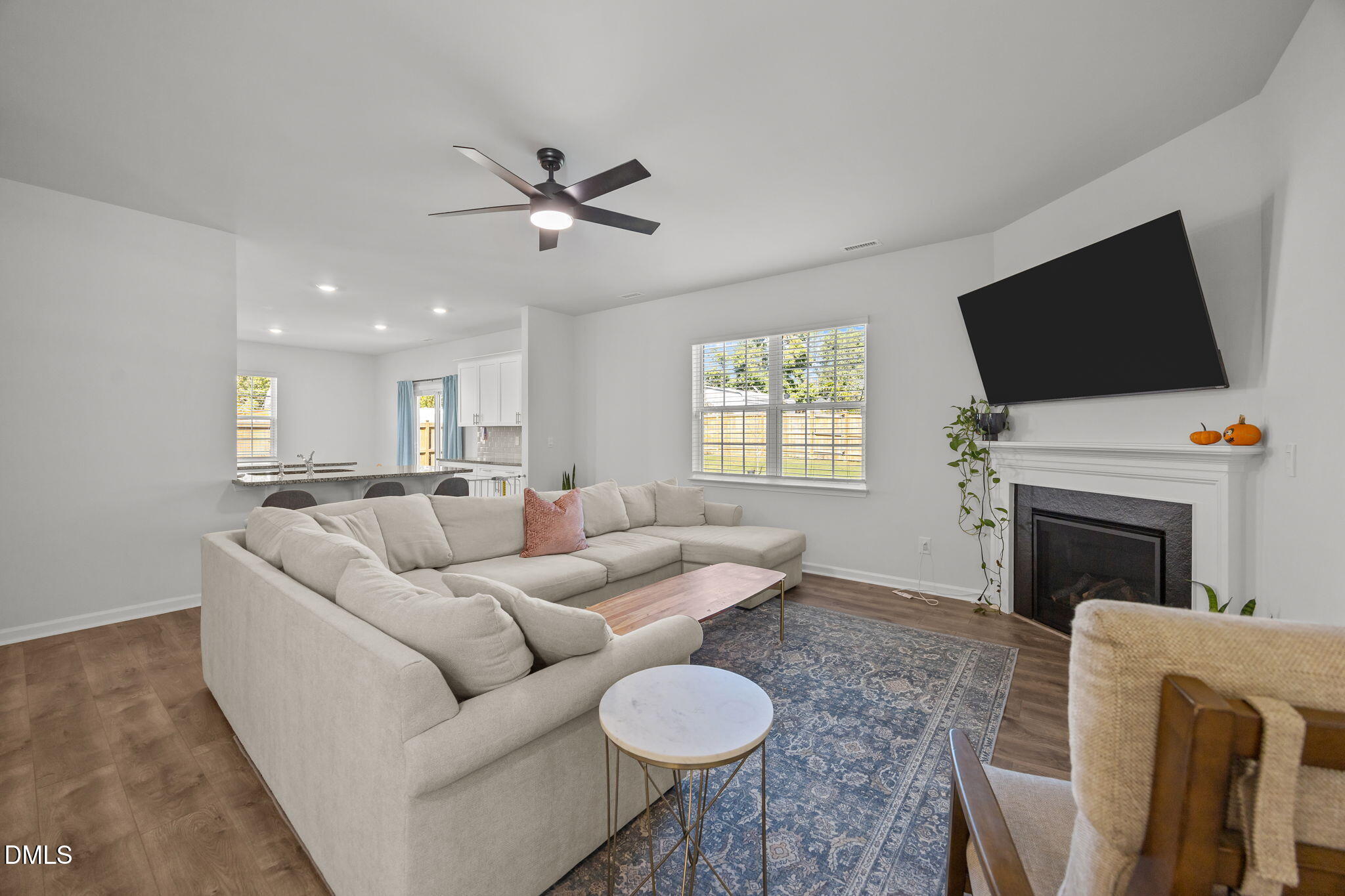 2117 Fletchers Ridge Drive Durham, NC 27703 - Photo 14 of 46 a living room with furniture a fireplace and a flat screen tv