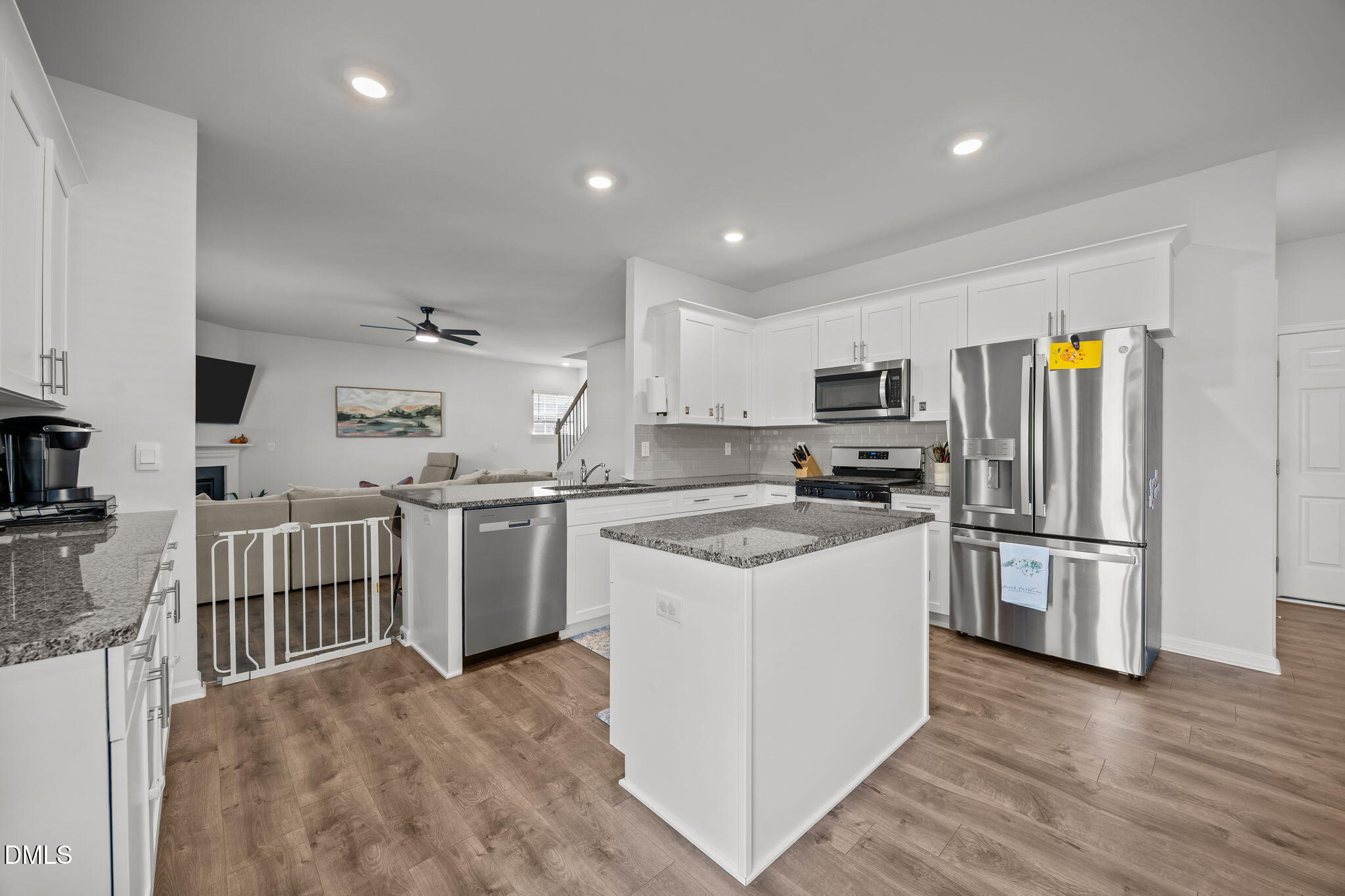 2117 Fletchers Ridge Drive Durham, NC 27703 - Photo 18 of 46 a kitchen with a refrigerator a stove top oven a sink dishwasher and wooden cabinets