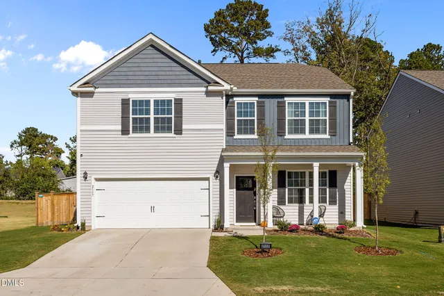 a front view of a house with a yard and garage