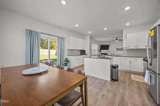 a kitchen with cabinets and wooden floor