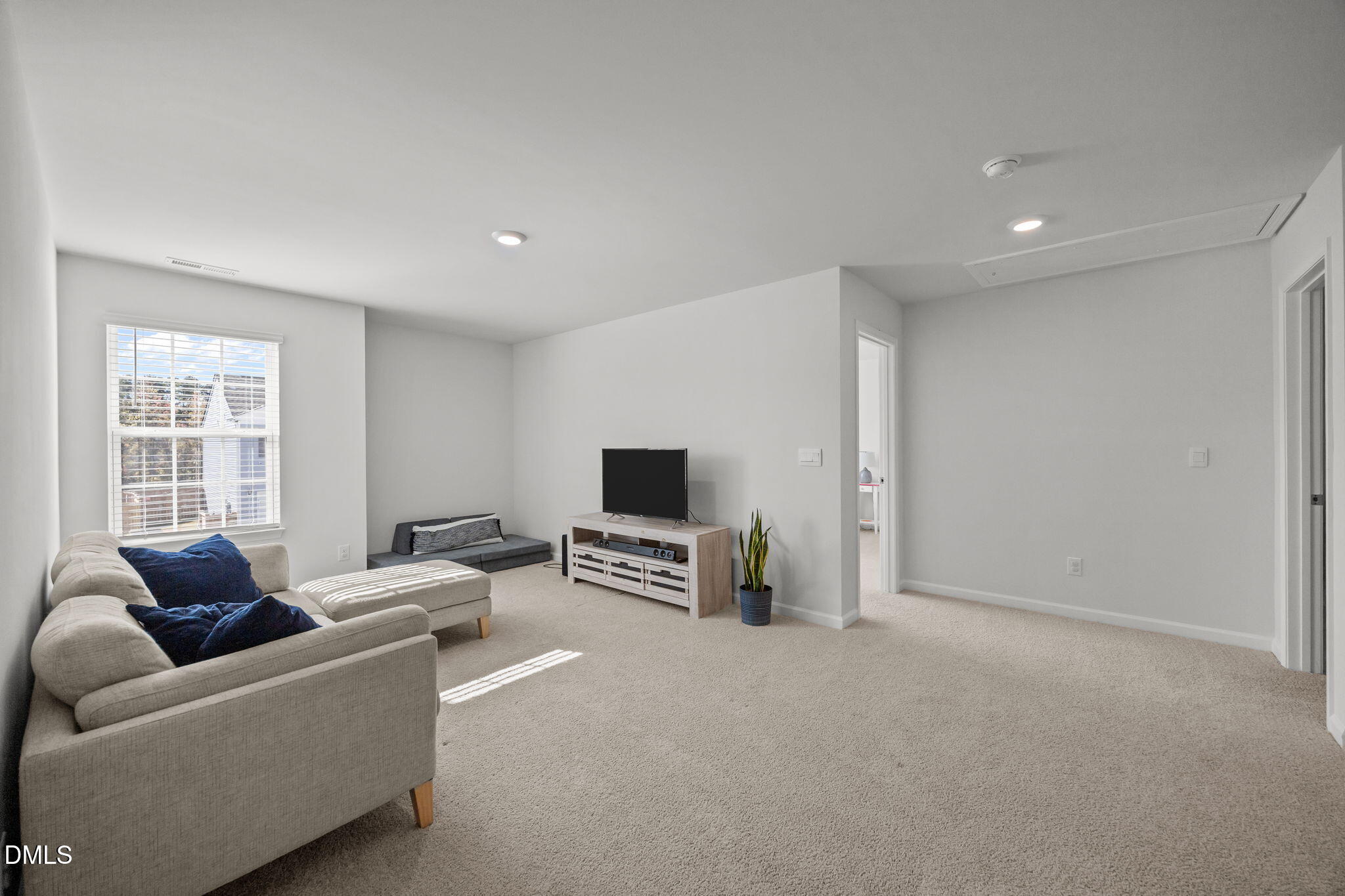 2117 Fletchers Ridge Drive Durham, NC 27703 - Photo 24 of 46 a living room with furniture and a flat screen tv