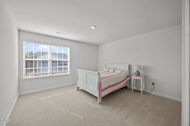 a living room with a bed and a ceiling fan