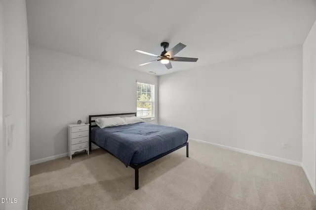 a bedroom with furniture and a window