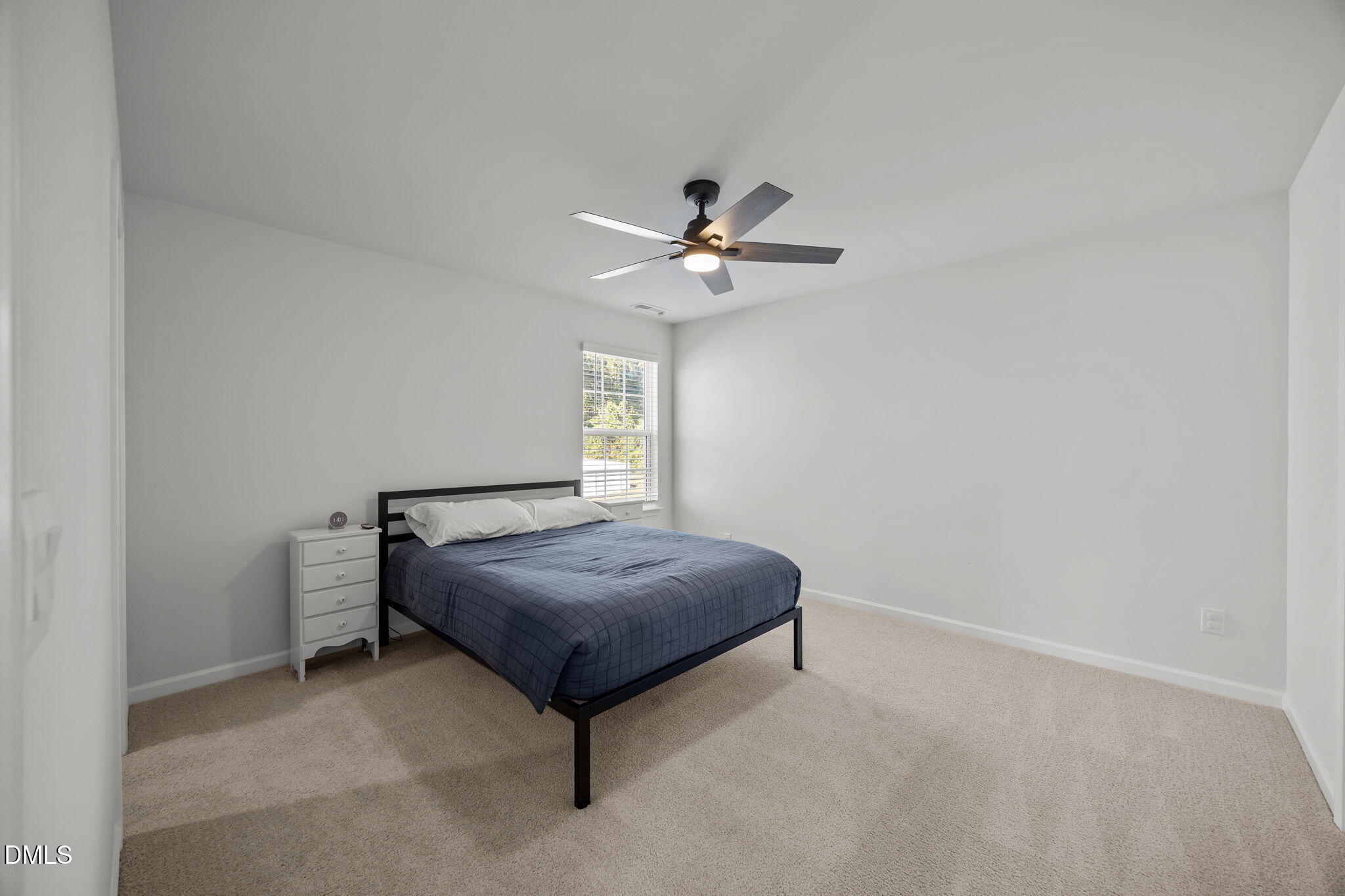 2117 Fletchers Ridge Drive Durham, NC 27703 - Photo 30 of 46 a living room with a bed and a ceiling fan