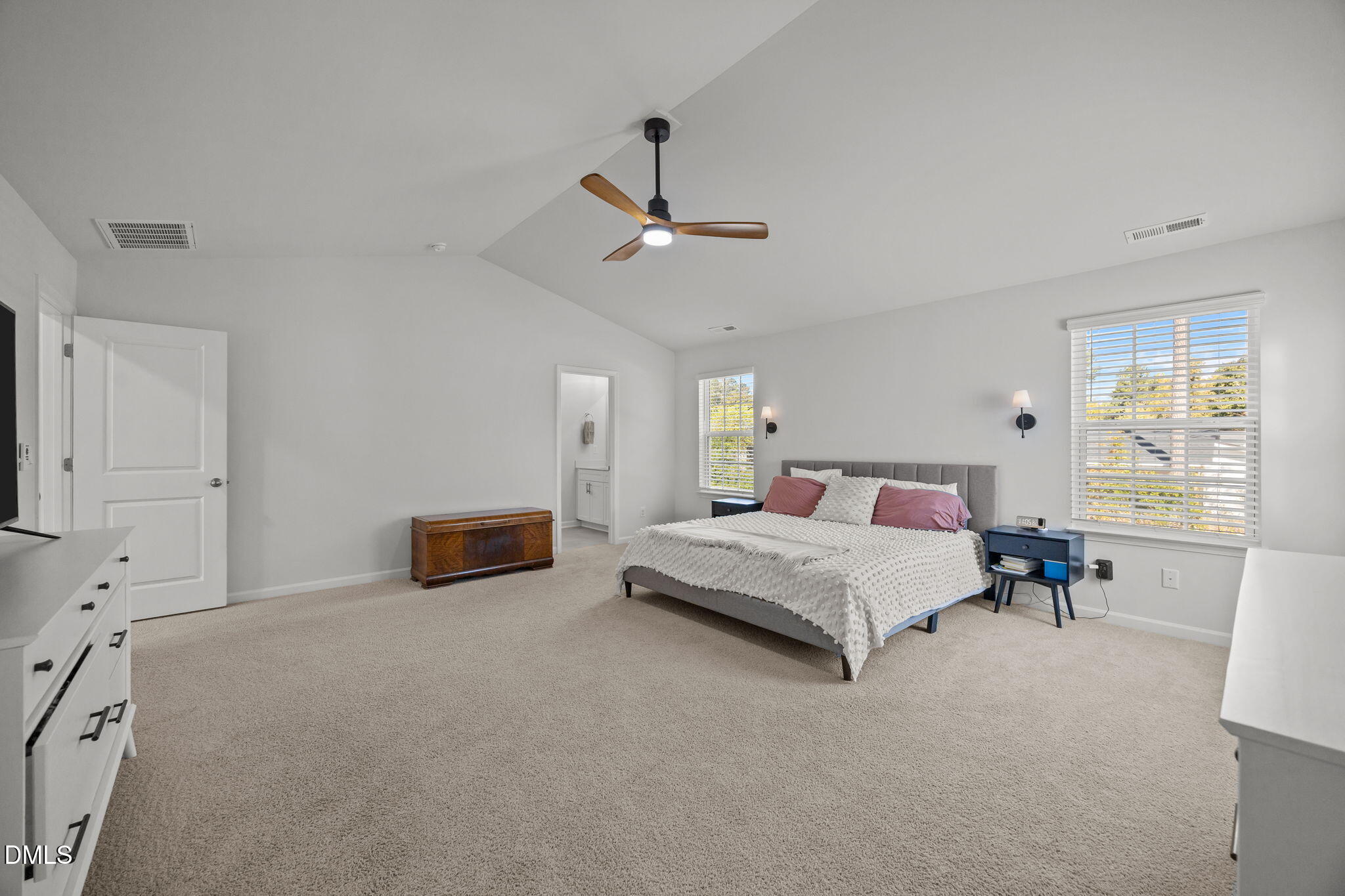 2117 Fletchers Ridge Drive Durham, NC 27703 - Photo 32 of 46 a spacious bedroom with a bed a table and chair