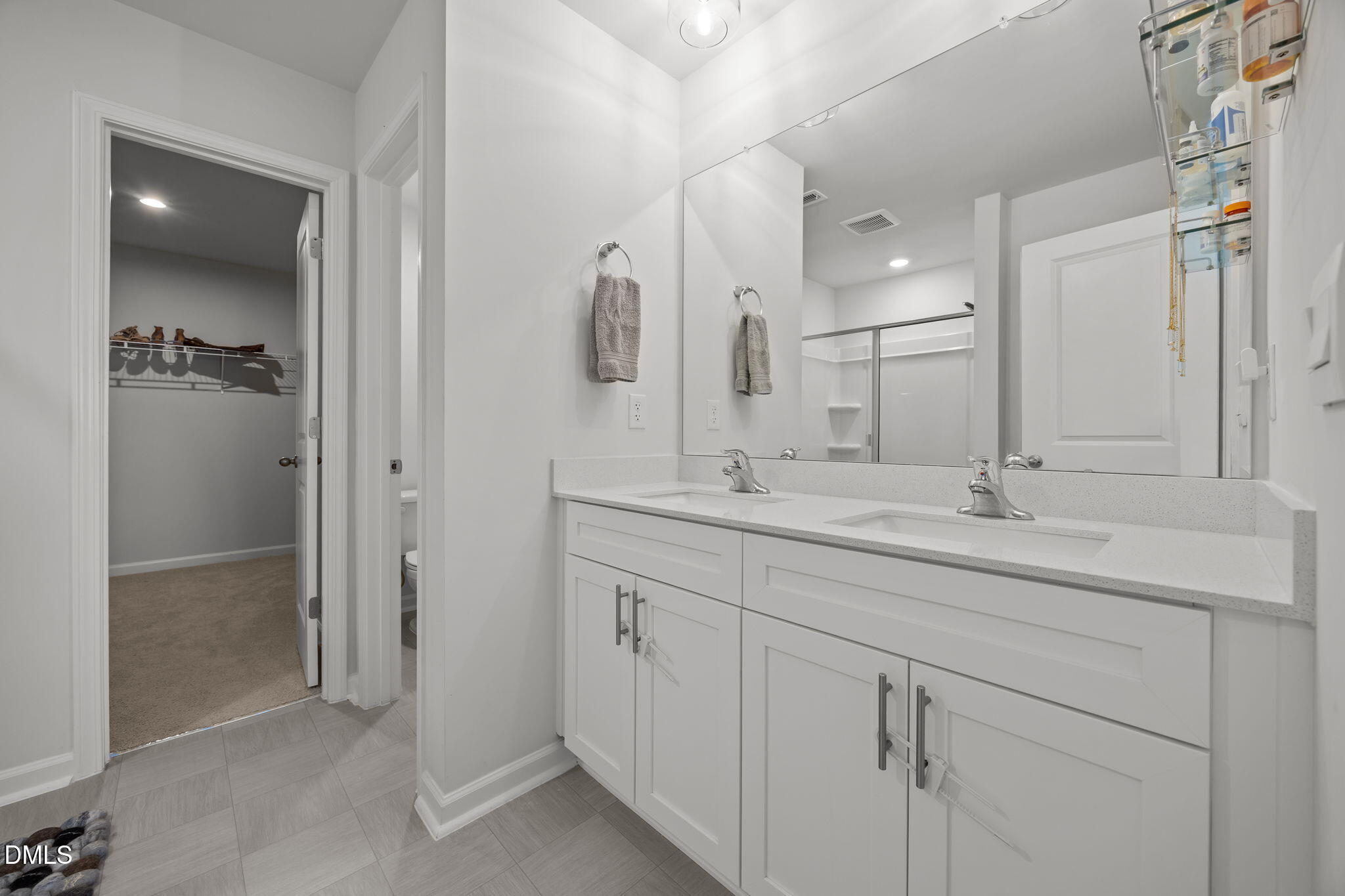 2117 Fletchers Ridge Drive Durham, NC 27703 - Photo 33 of 46 a bathroom with double sink and a mirror