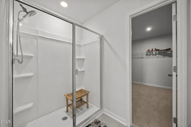 a view of walk in closet with clothes