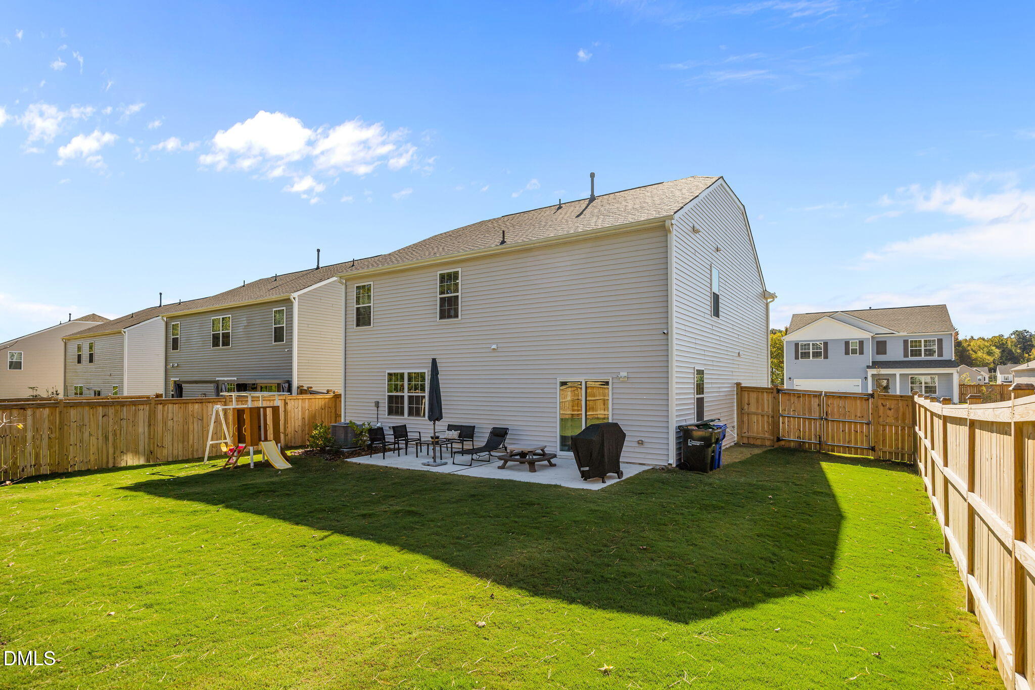 2117 Fletchers Ridge Drive Durham, NC 27703 - Photo 37 of 46 a view of a backyard with couches under an umbrella