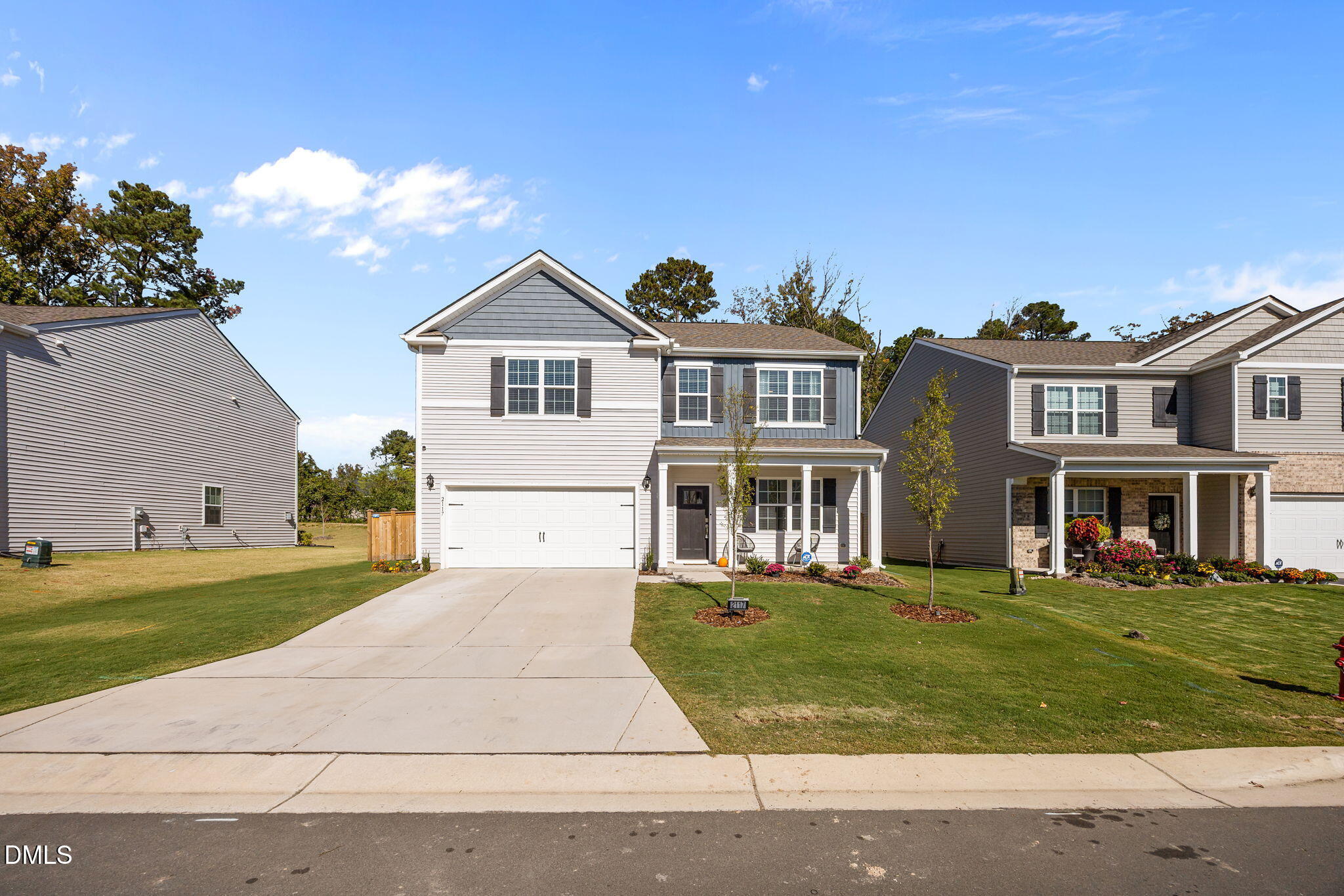 2117 Fletchers Ridge Drive Durham, NC 27703 - Photo 45 of 46 a front view of a house with a garden and trees