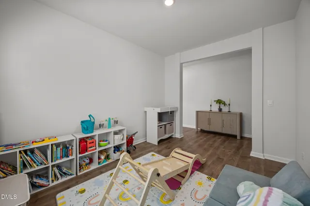 a living room with furniture and a book shelf