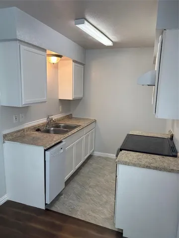 a kitchen that has a sink and a stove in it