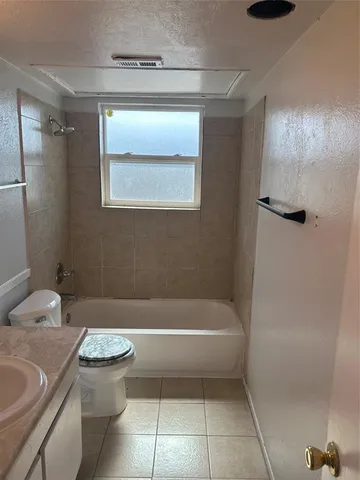 a bathroom with a toilet and a bath tub
