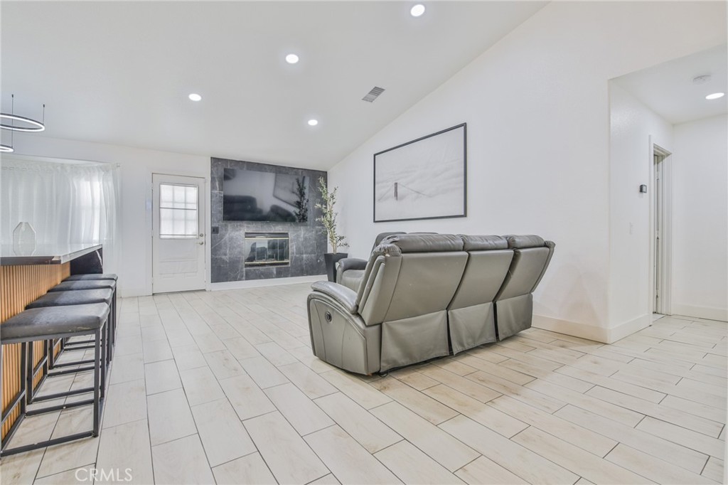 7925 Victor Avenue Hesperia, CA 92345 - Photo 12 of 23 a living room with furniture and a fireplace