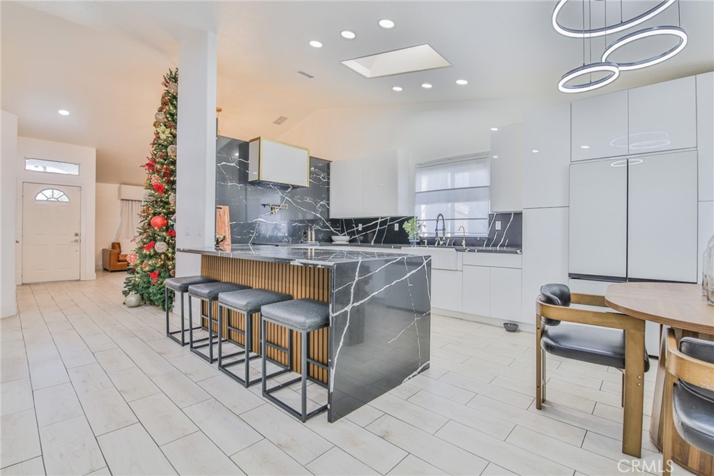 7925 Victor Avenue Hesperia, CA 92345 - Photo 13 of 23 a kitchen with stainless steel appliances kitchen island granite countertop a sink and cabinets
