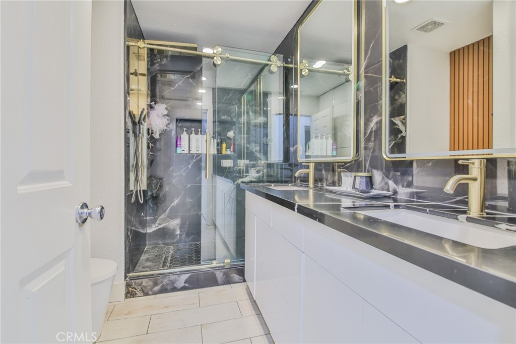 7925 Victor Avenue Hesperia, CA 92345 - Photo 18 of 23 a bathroom with a shower sink and mirror