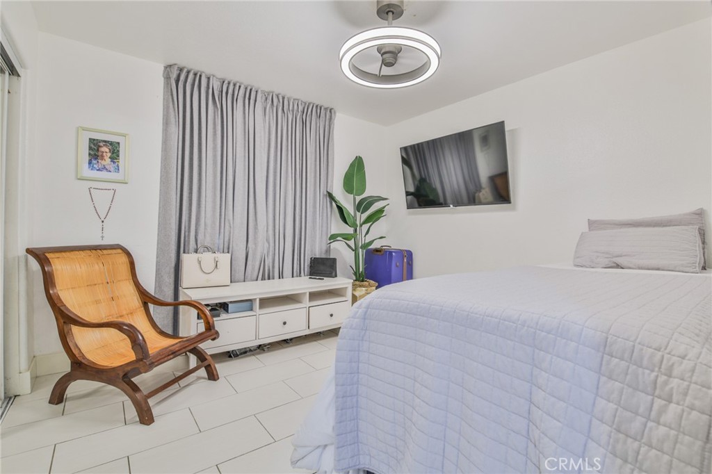 7925 Victor Avenue Hesperia, CA 92345 - Photo 19 of 23 a bedroom with a bed and a chair