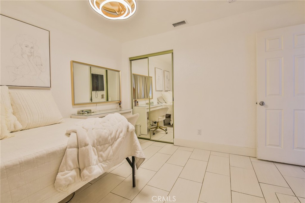 7925 Victor Avenue Hesperia, CA 92345 - Photo 20 of 23 a bed room with a bed and a mirror