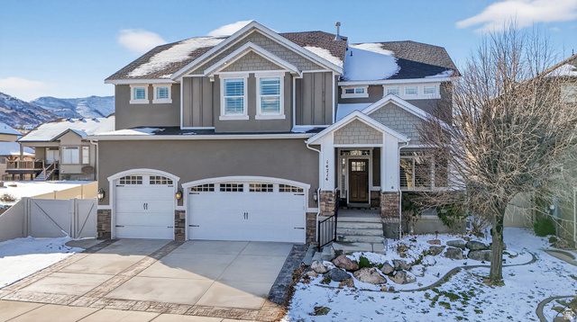 14714 South Bright Wood Road Herriman, UT 84096 - Photo 1 of 41 Craftsman-style home featuring stone siding, an attached garage, stucco siding, and concrete driveway