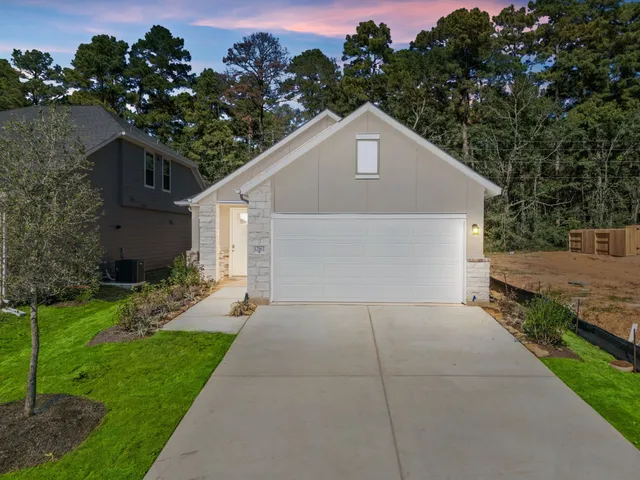 a house with green field in front of it