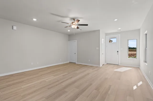 an empty room with fan and a ceiling fan