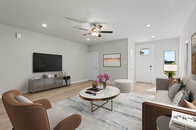 a living room with furniture and a flat screen tv