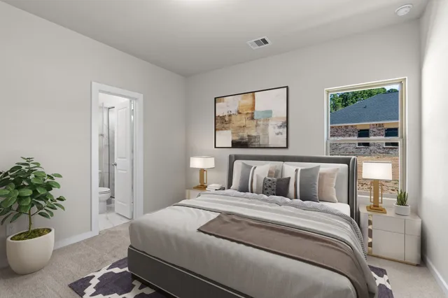 a bedroom with a large bed and a potted plant