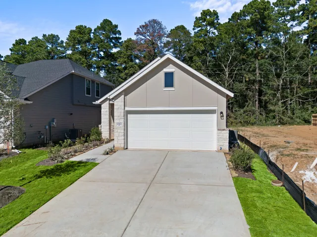 a view of a house with a yard and a garage