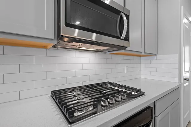 a stove top oven sitting inside of a kitchen