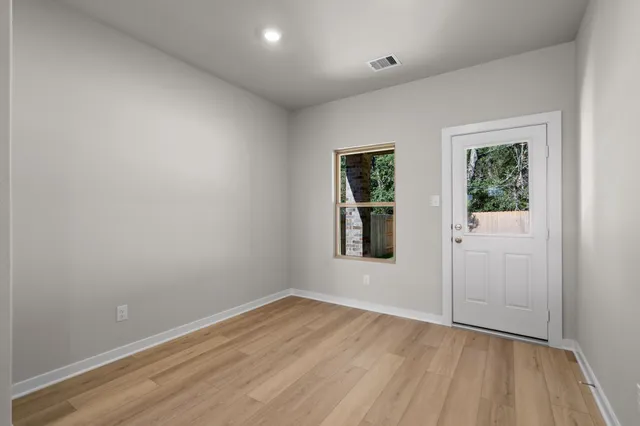 wooden floor in an empty room with a window