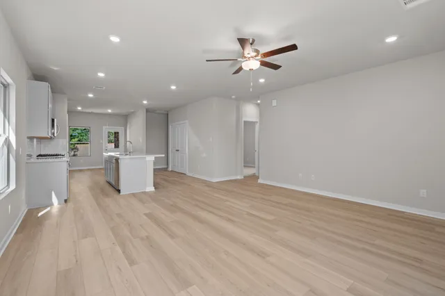 a view of a kitchen with a sink and refrigerator