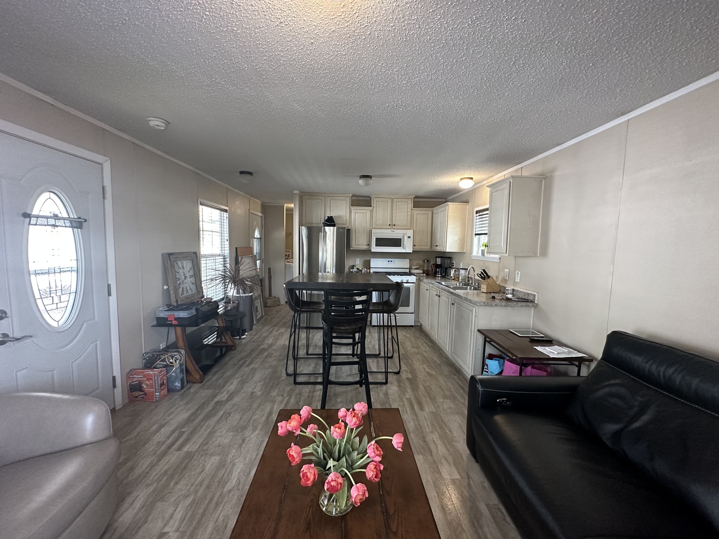 a living room with furniture and kitchen view