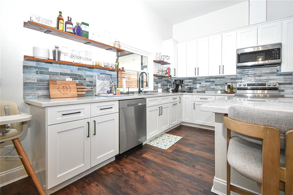 7890 Southwest 129th Avenue Cedar Key, FL 32625 - Photo 11 of 45 a kitchen with a sink cabinets and wooden floor