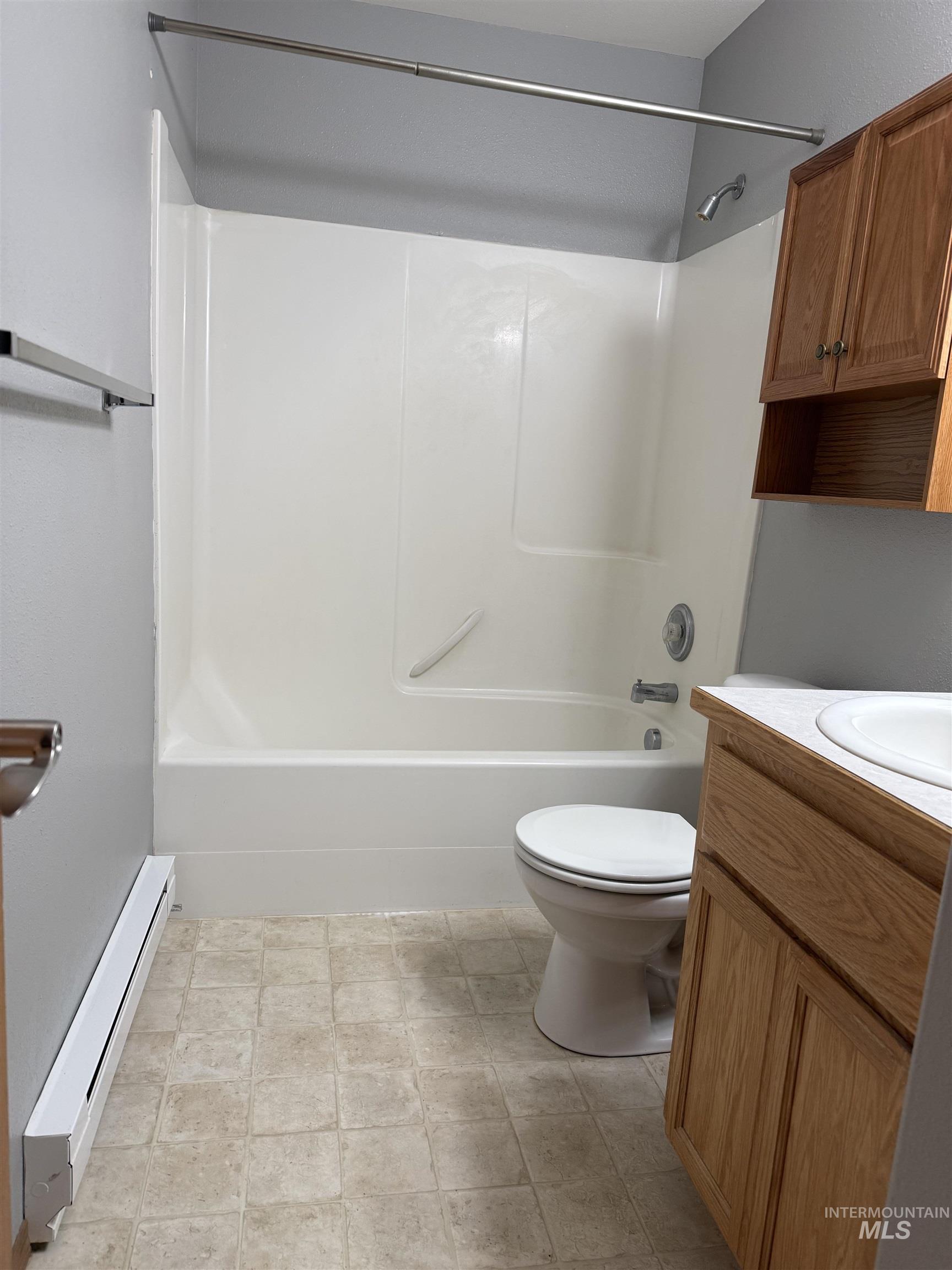 257 Pintail Lane Moscow, ID 83843 - Photo 9 of 28 Bathroom with vanity, baseboard heating, and washtub / shower combination