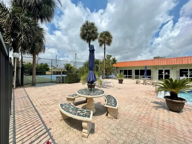 a swimming pool with outdoor seating yard and barbeque oven