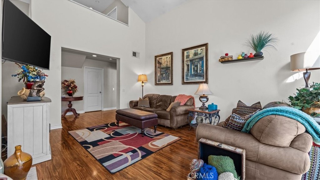 1671 Dominguez Ranch Road Corona, CA 92878 - Photo 6 of 42 Spacious and airy, this living area features high ceilings, warm finishes, and a seamless flow into adjacent spaces, creating a comfortable setting for gatherings.