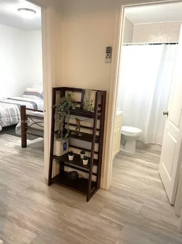 a view of a room with a furniture and wooden floor