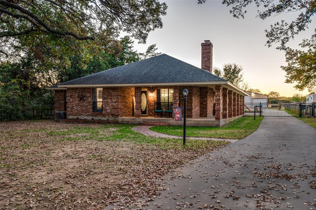 a view of a house with a yard and porch